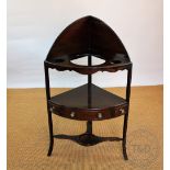 A George III mahogany corner wash stand, three tier with one real and two dummy drawers,
