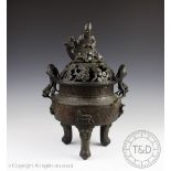 A large Chinese bronze censor, koro and cover, the cover surmounted with a seated man and deer, lu,