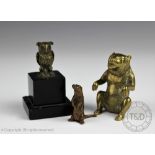 A small cast bronze otter, modelled standing upon hind legs, marked to underside, 4cm high,