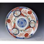 A late 19th century Japanese porcelain Imari charger, decorated with bamboo and prunus blossom,
