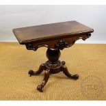 A Victorian mahogany tea table, with baluster column, on four scroll legs,