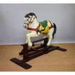 A Victorian style carved and painted wood rocking horse, on mahogany base,