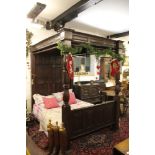 A 17th century style mahogany four poster bed, with panelled back board and foot board,