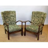 A pair of 1930's vintage beech easy chairs, with patterned floral upholstery and turned uprights,