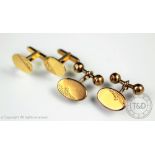 A pair of 9ct gold cufflinks, designed as an oval disc with bar link, weight 6.