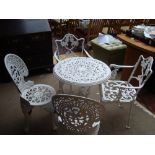 A cast iron white painted garden table together with two cast iron garden chairs and two other