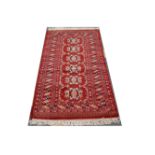 A Pakistan style red ground runner. 161 x 78cm.