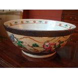 A crackle glazed oriental bowl depicting a battle, with heavy restoration to one side.