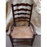 A 19th Century ash Lancashire ladderback armchair with rush seat.