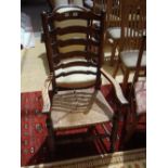 A 19th Century ash Lancashire ladderback low armchair.