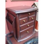 A miniature chest / cabinet, with holders to the sides and on wheels, 41cm high.