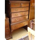 A two section chest, one drawer opening to reveal a bureau compartment, with two short drawers
