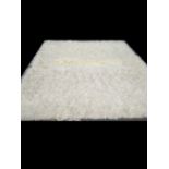 A flokati woolen rug, small area of discolouration. 360 x 245 cm.