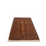 A brown/cream ground rug. 164 x 95cm.