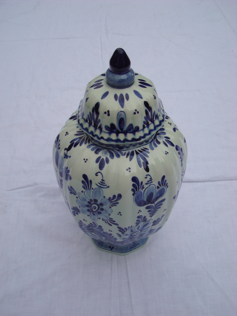 A Delft blue and white hand painted vase with lid.