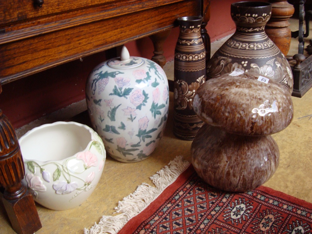 A glazed ceramic mushroom, planter and various vases.