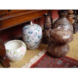 A glazed ceramic mushroom, planter and various vases.