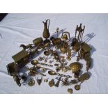 A mixed lot of brass including horses and carriages, fire tools, small figures, tankards, bell etc.