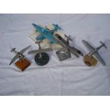 Six model aircraft on stands comprising one on wooden base, one on plastic stand, a K 1938 on marble