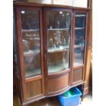 An Edwardian bow fronted display cabinet.