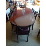 A reproduction mahogany twin pedestal dining table together with six chairs.