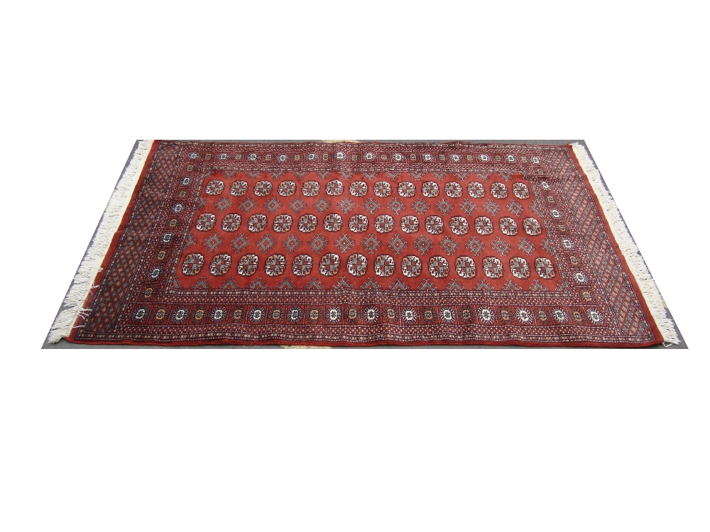 A red ground rug. 188 x 130cm.