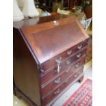 A mahogany bureau, the lift down top enclosing six drawers, a small cupboard with drawer inside