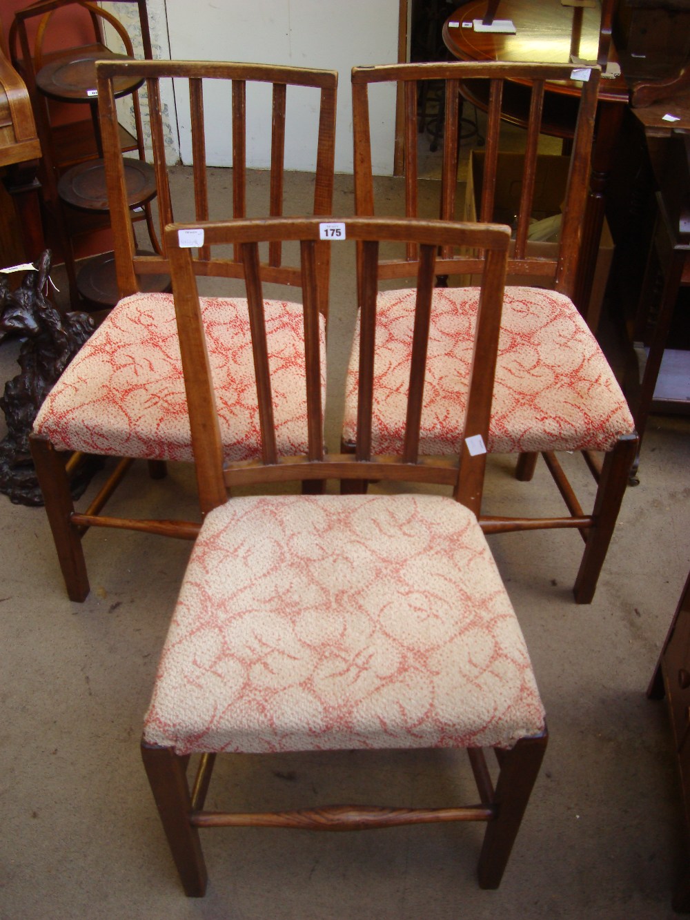 A set of three George III elm country dining chairs, with curved square backs and moulded upright