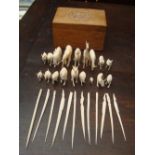 A box of ivory animals and spillikins.