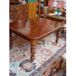 A mahogany dining table, length with two extra leaves 22cm long x 106cm wide x 70cm high.