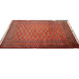 A large red ground rug (area of wear). 280 x 193cm.