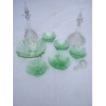 A mixed lot of glass comprising eleven small green glass dishes and one large, two decanters and