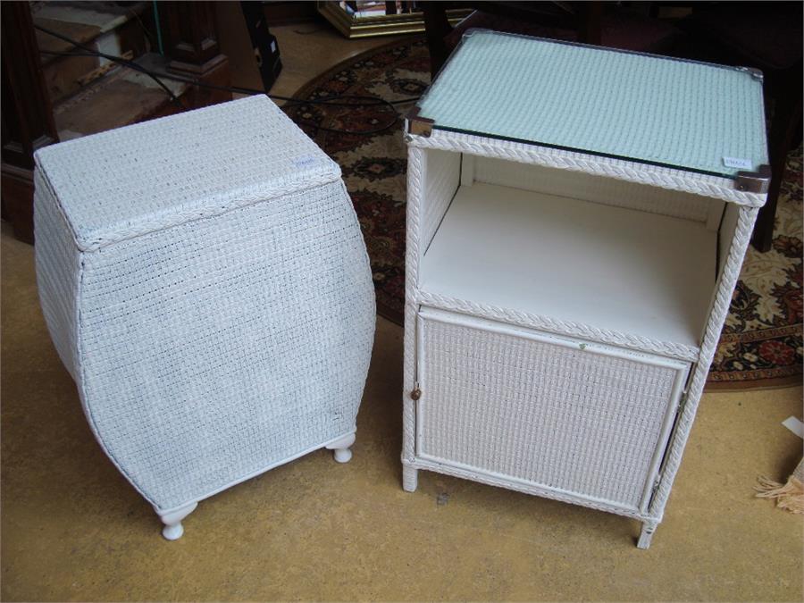 A Lloyd Loom white painted bedside cupboard together with a linen basket (2).