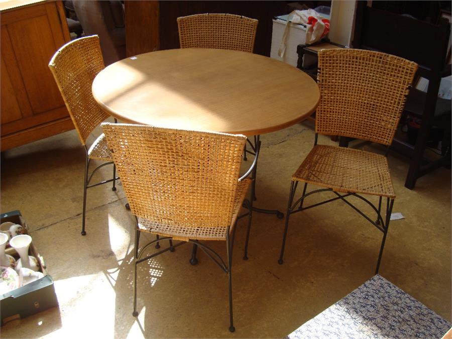 A pine conservatory table together with four woven chairs, 102cm diameter.