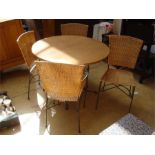A pine conservatory table together with four woven chairs, 102cm diameter.