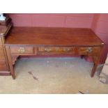 An ironwood hard table with three drawers.