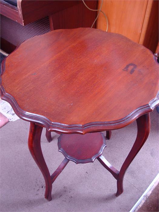 A side table with pie crust edge, on four legs. 73cm high.