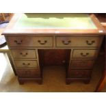 A reproduction childs writing desk, with locking compartment to centre, three small drawers on
