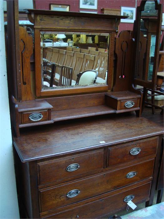 An Art Nouveau oak dressing chest.