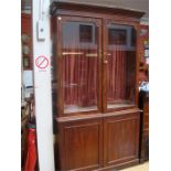 A Victorian mahogany bookcase, with glazed doors above a cupboard. 123 x 41.5 x 225cm high.