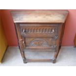 A 19th Century oak cupboard, carved in 17th Century style with fluted frieze drawer above a cupboard