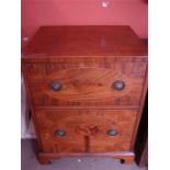 A two cupboard cabinet, with brass handles, the upper compartment with sliding door and the lower