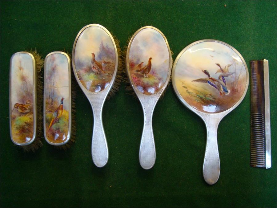 A dressing table set comprising brushes, a hand mirror and a comb.  With Royal Worcester porcelain