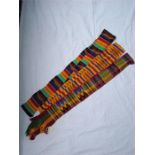 Three Kente cloth belts, Ghana.  One in orange, blue and purple; one decorated in purple, green,