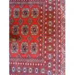 A red ground Pakistan style rug, 190 x 130cm.