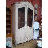 A large cream painted French wardrobe, with drawer to base and two glazed cupboard doors. 135 x 51 x