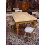 A pine farmhouse table, on turned legs 136cm long x 91cm wide x 77cm high, together with a set of