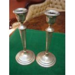 A pair of Edwardian silver candlesticks with loaded bases. Of tapering form, Birmingham, 1911 by