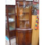 A reproduction corner display cabinet.