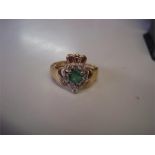 A 14 carat yellow gold Claddagh ring, emerald heart cut. 12 brilliant cut cluster (one stone